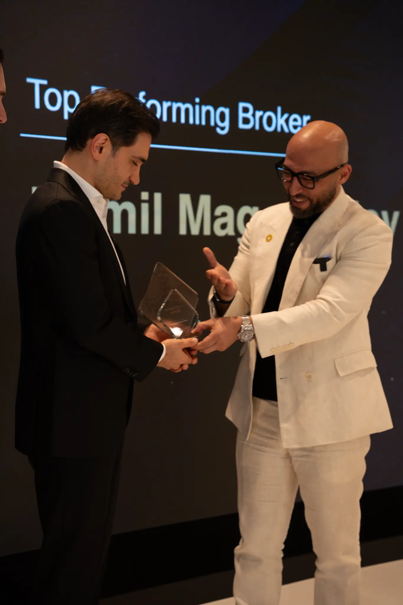 Karim ElSayyad, Vice President of Sales at Expo City Dubai, presenting the Top Performing Broker trophy to Kamil Magomedov at the official ceremony